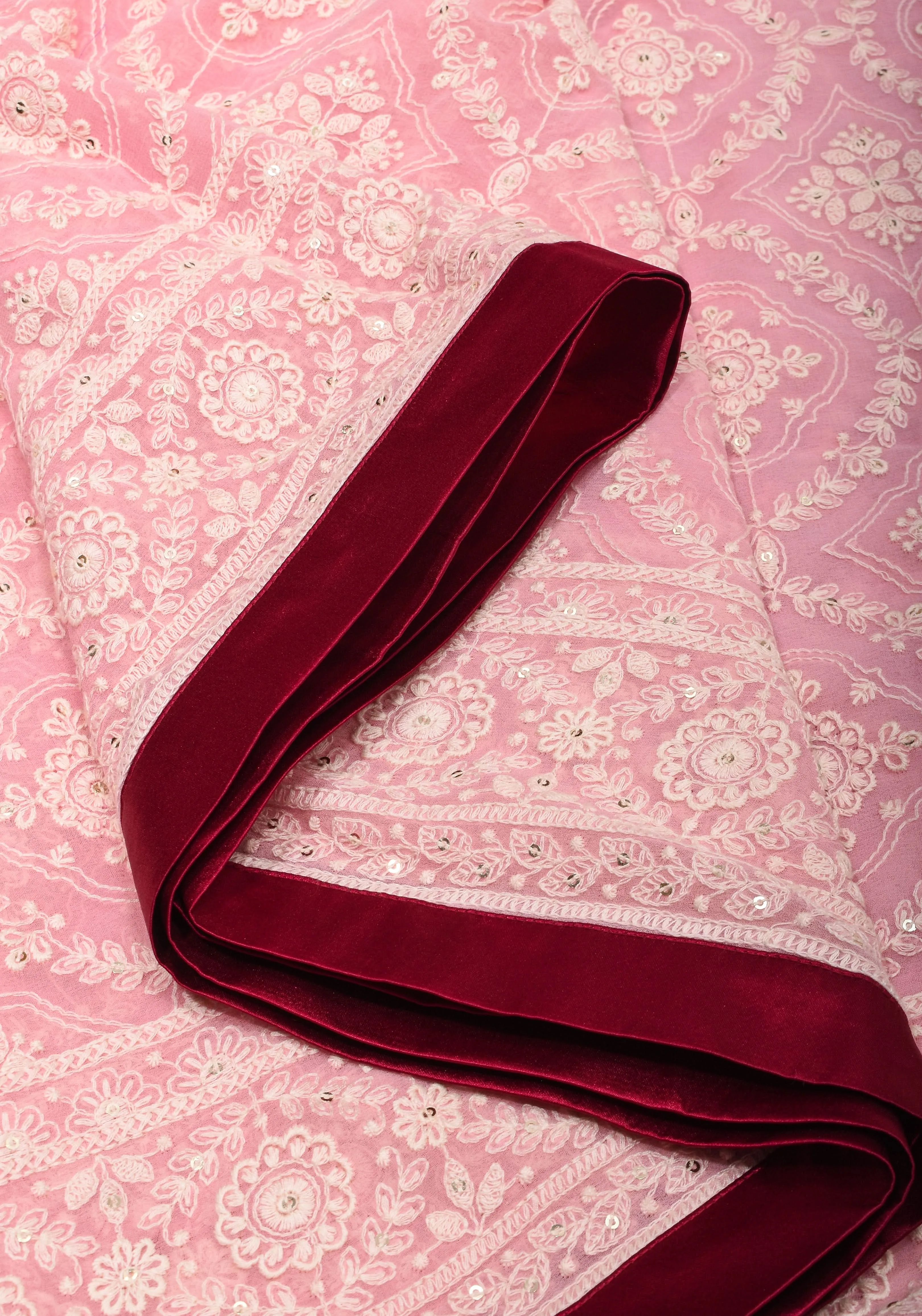 Charming Pink Georgette Saree with Self Embroidery and contrasting Pomegranate satin trim